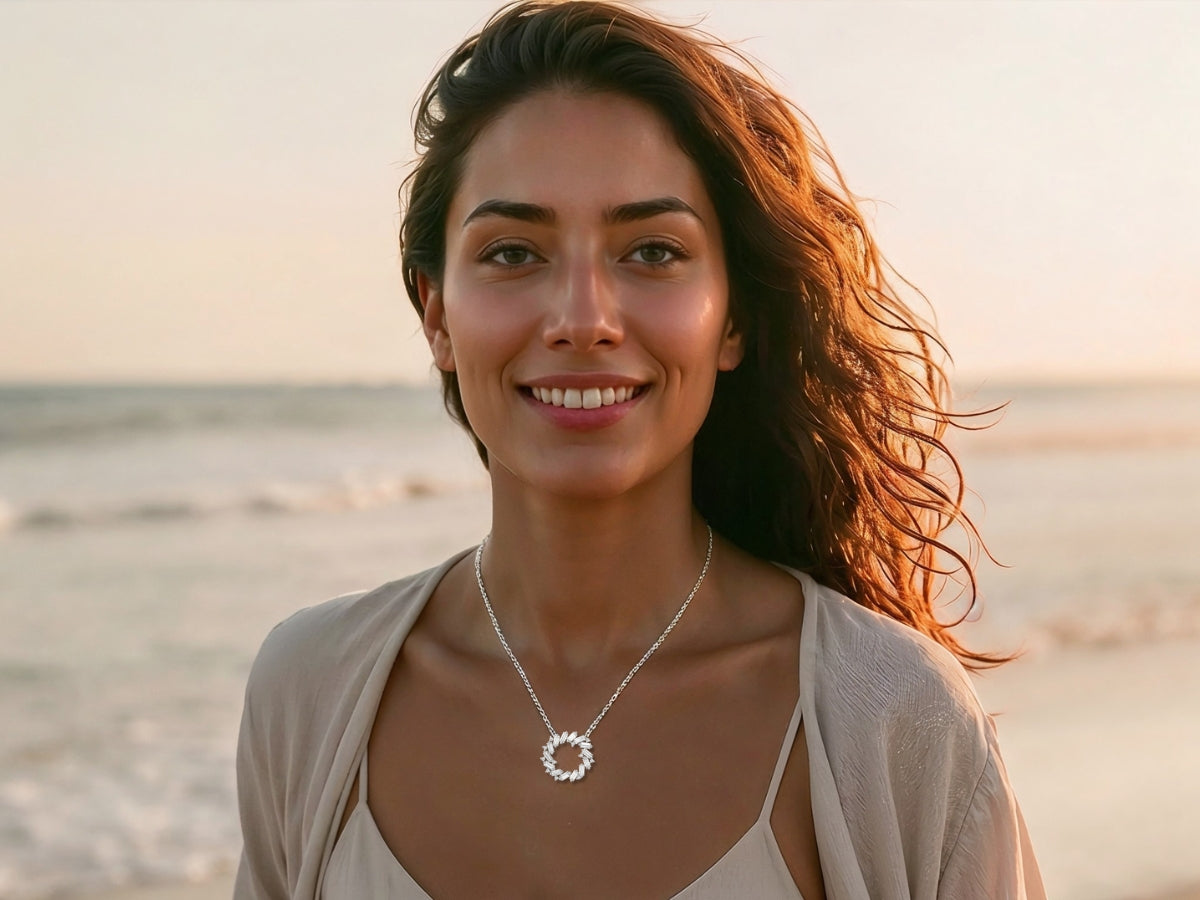 woman wearing moissanite circle necklace smiling at beach lifestyle elegant sterling silver jewelry with everyday sparkle and timeless design