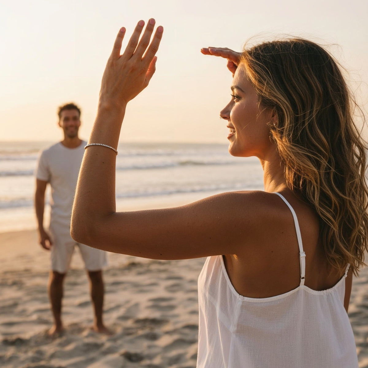 Woman wearing a LOVE&LOVE bracelet while walking by the sea, capturing a relaxed everyday moment